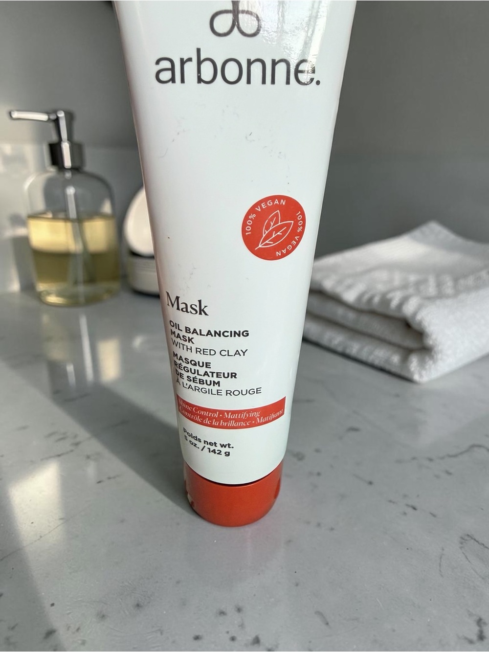 Arbonne Oil Balancing Mask with a red Clay